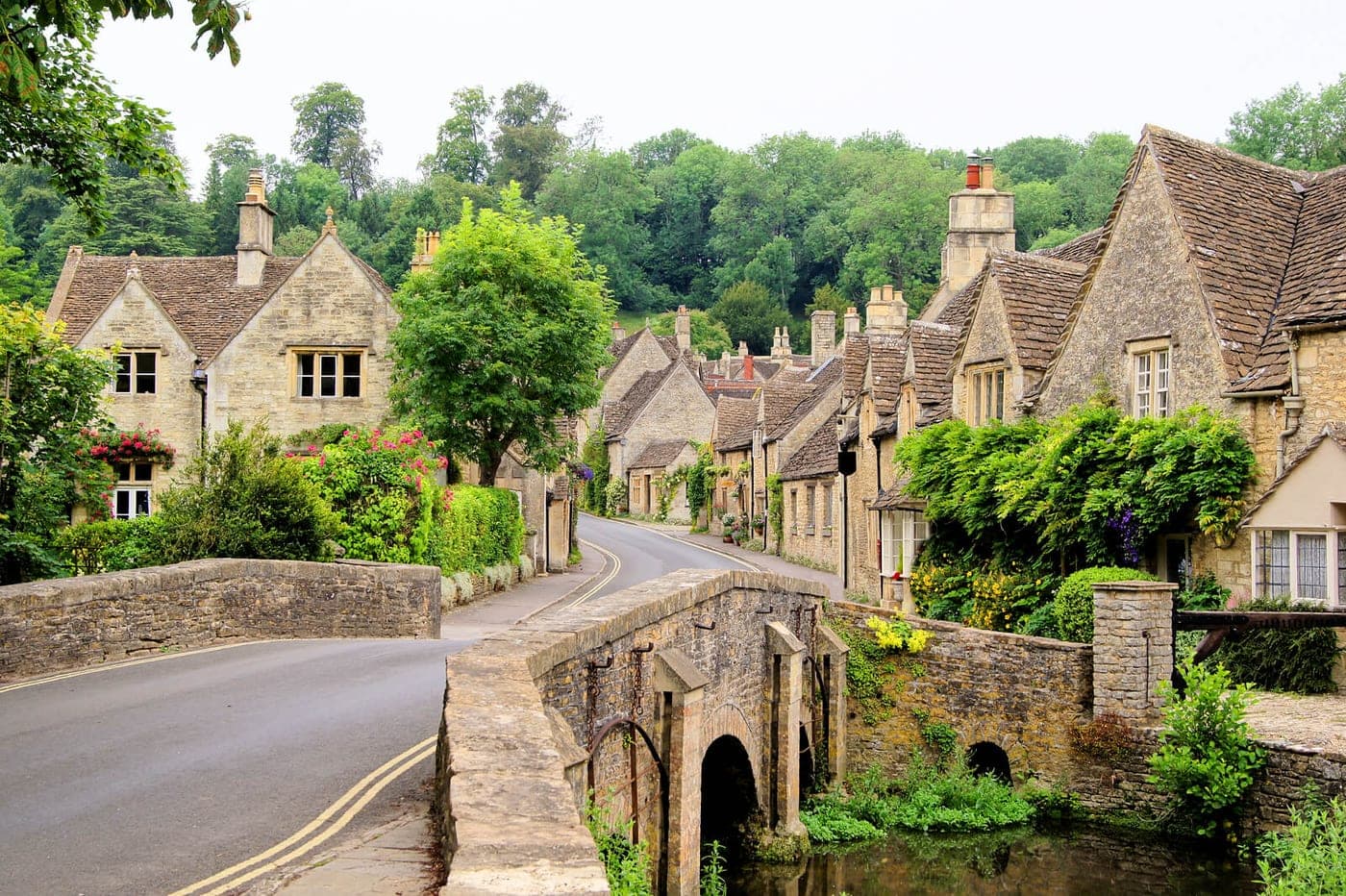 Honey-stone cottages along a Cotswolds village street