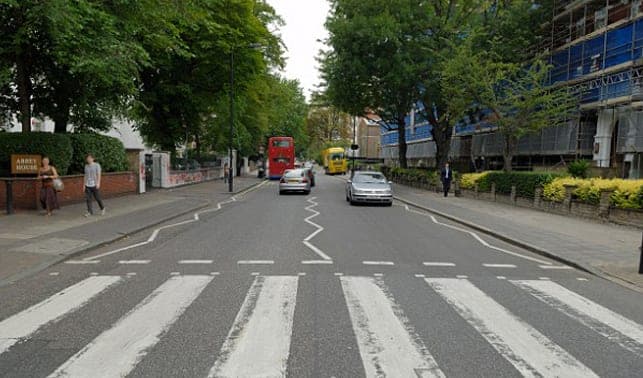 The zebra crossing on Abbey Road lined with trees