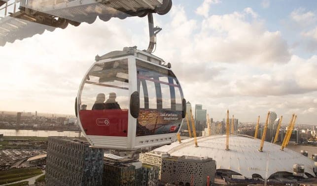 A cable car cabin above the river with the O2 dome below