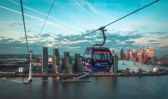 An IFS Cloud Cable Car cabin above the river and Docklands skyline